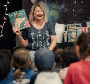 Woman reading to kids